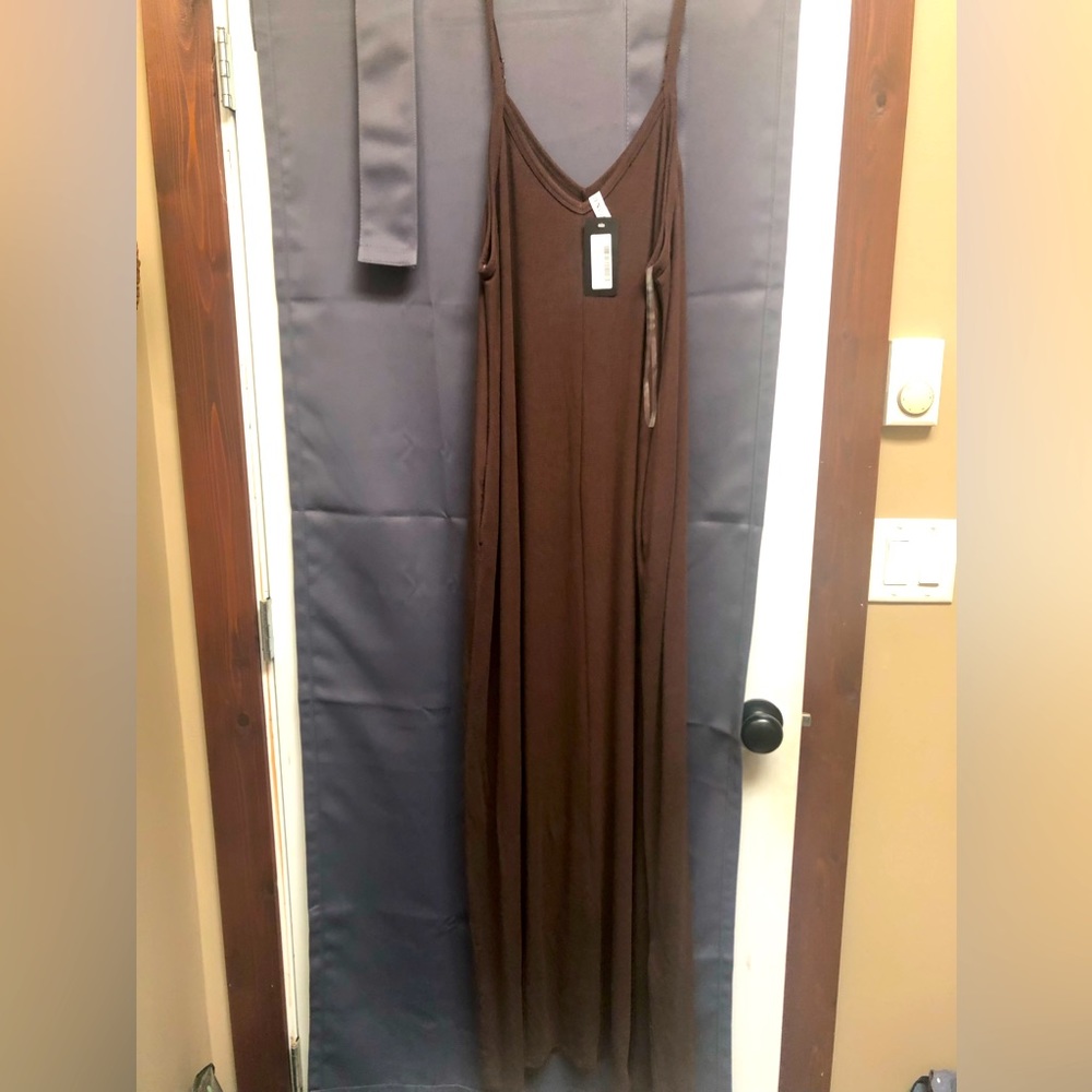 New with tags brown maxi dress with pockets.  Adjustable straps.